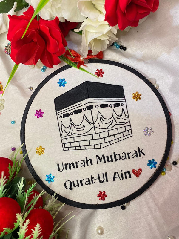 Handmade Hoop Embroidery Art titled "Umrah Mubarak: Islamic Blessings Hoop Art" featuring Islamic-inspired designs, crescent moons, mosques, and floral patterns, displayed in a hoop.