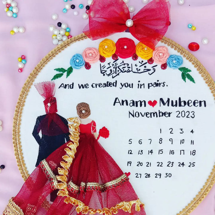 Handmade Hoop Embroidery Art titled "Created in Pairs: Anam & Muleen Wedding Hoop Art" featuring a meaningful quote, names, and intricate floral embroidery, displayed in a hoop.