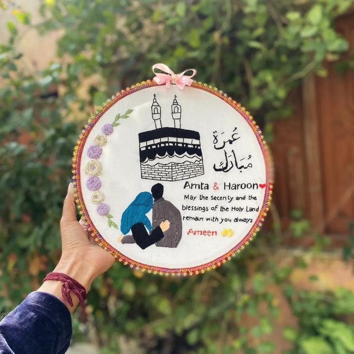 Handmade Hoop Embroidery Art titled "Blessings of the Holy Land: Islamic Hoop Art" featuring a heartfelt message and intricate Islamic-inspired designs, displayed in a hoop.