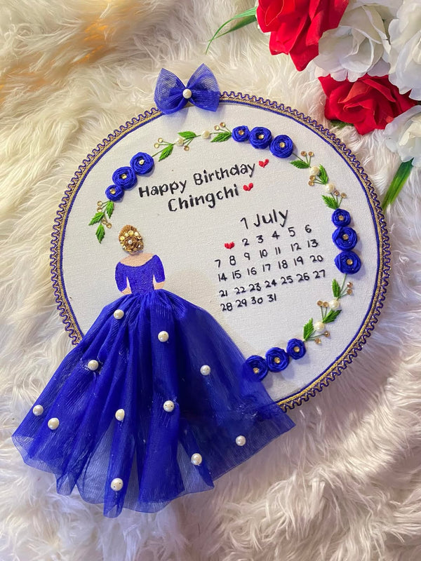 Handmade Hoop Embroidery Art titled "Chingchi's Birthday Celebration" featuring vibrant and intricate birthday-themed design, displayed in a standard embroidery hoop.